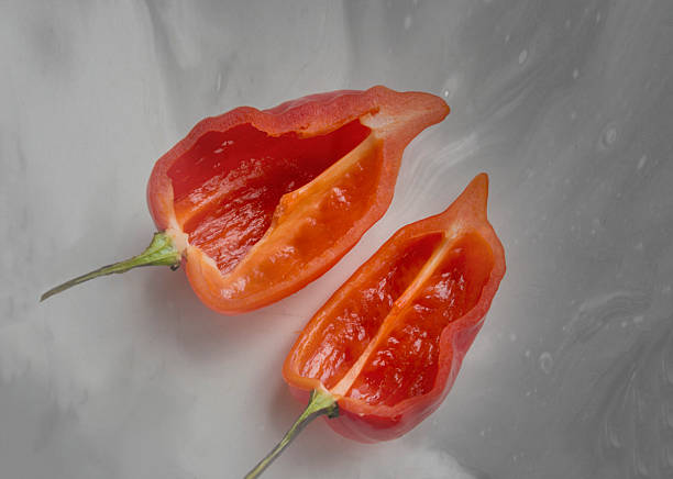 after half red aji chile pepper stock photo