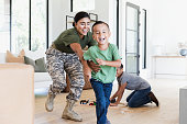 istock After work, female soldier chases son in house 1356430957