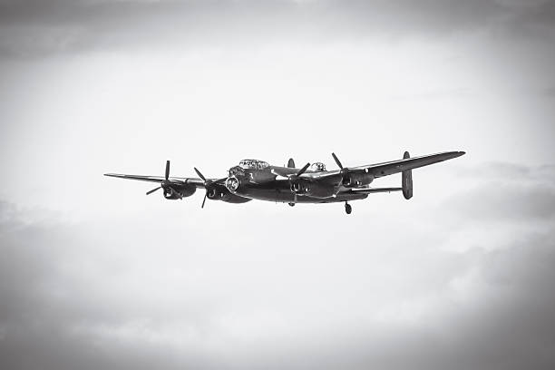 Aged image of an Avro Lancaster in flight wheels up stock photo