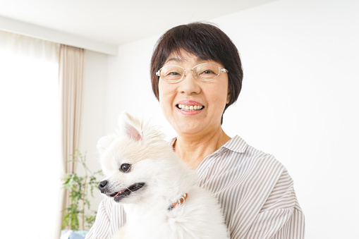 Aged woman having a dog