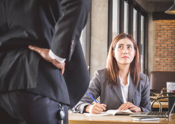 Aggressive/angry boss complaining asian business woman(casual uniform) in cafe office Aggressive/angry boss complaining asian business woman(casual uniform) in cafe office aggression stock pictures, royalty-free photos & images