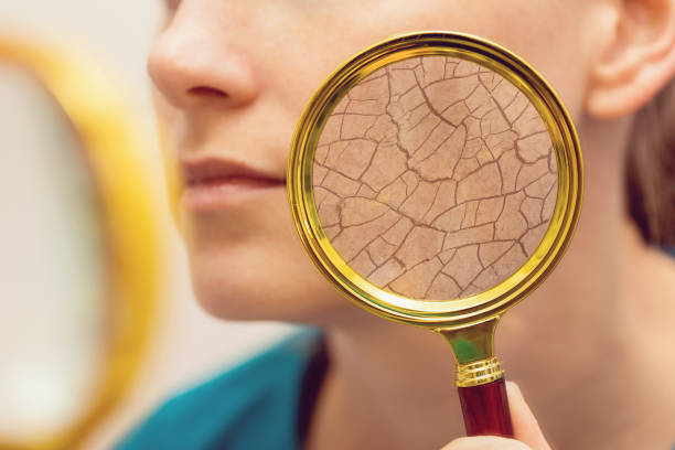 aging and dry face skin concept - woman with magnifying glass aging and dry face skin concept - woman with magnifying glass Dry skin stock pictures, royalty-free photos & images