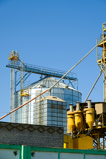 Agricultural Silos. Building for storage and drying of grain crops. Modern granary elevator. Agribusiness concept.
