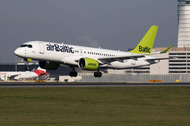 Air Baltic Airbus A220-300 YL-CSJ passenger plane arrival and landing at Vienna International Airport Vienna / Austria - April 18, 2019: Air Baltic Airbus A220-300 YL-CSJ passenger plane arrival and landing at Vienna International Airport baltic countries stock pictures, royalty-free photos & images