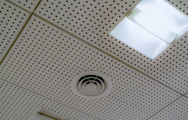Air conditioner. Air duct and ceiling lamp light mount on ceiling of hospital, hotel, or office building. Cool system in the building. Air flow and ventilation system. AHU air conditioning system. stock photo