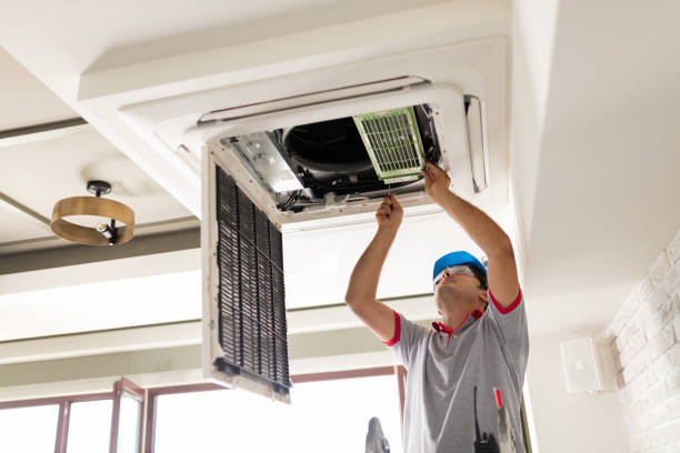 Air conditioner install Electrician fitting air conditioning to office interior building maintenance stock pictures, royalty-free photos & images