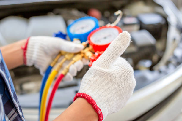 Air Conditioning Repair, Repairman giving thumbs up and holding monitor tool to check and fixed car air conditioner system, Technician check car air conditioning system refrigerant recharge stock photo