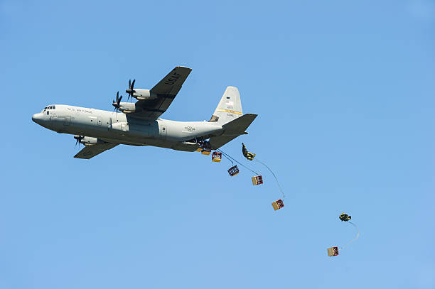 Air Force C-130 dropping cargo stock photo