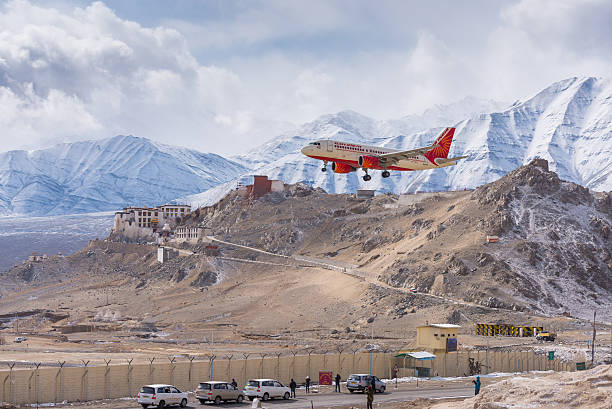 Air India plane landing passing monastery Leh, India - February 16, 2014: Air India plane landing passing monastery in Ladakh on February 16, 2014 at Leh, India leh district stock pictures, royalty-free photos & images