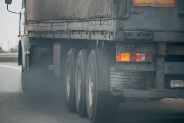 Air pollution from truck vehicle exhaust pipe on road stock photo