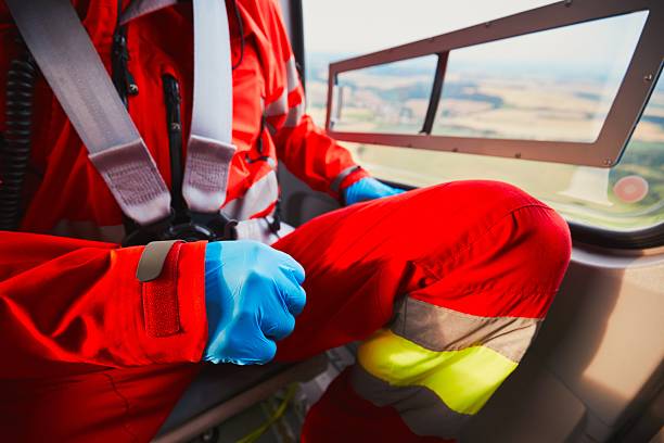 Air rescue service Alarm for the air rescue service. Doctor is preparing in the helicopter emergency medical service. - selective focus on the glove emergency response stock pictures, royalty-free photos & images