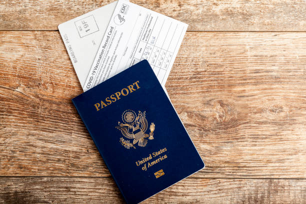 Air travel during COVID-19 pandemic concept with passport, boarding card and vaccination record card stock photo