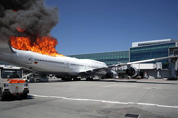 Airliner at gate engulfed in fake flames stock photo