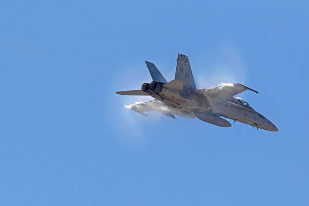 Airplane F-18 Hornet jet fighter breaking the sound barrier stock photo