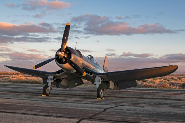 Airplane F4-U Corsair vintage WWII fighter on the runway during sunrise Los Angeles, California, USA - March 25,2017. WWII F4-U Corsair vintage fighter aircraft on the runway during the 2017 Los Angeles Air Show in Los Angeles, California. The 2017 Los Angeles Air Show features 2 days of military aircraft and the Thunderbirds performing for the general public. ww2 american fighter planes stock pictures, royalty-free photos & images
