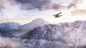 istock Airplane flying near the Beautiful Canadian Mountain Nature Landscape 1309504726