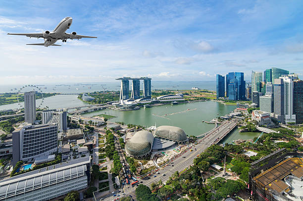 Airplane flying over Singapore stock photo