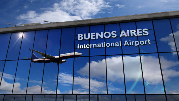 Airplane landing at Buenos Aires mirrored in terminal stock photo