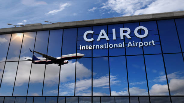 Airplane landing at Cairo mirrored in terminal stock photo