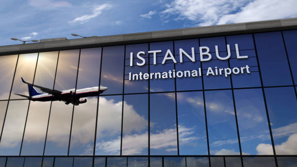 Airplane landing at Istanbul mirrored in terminal stock photo