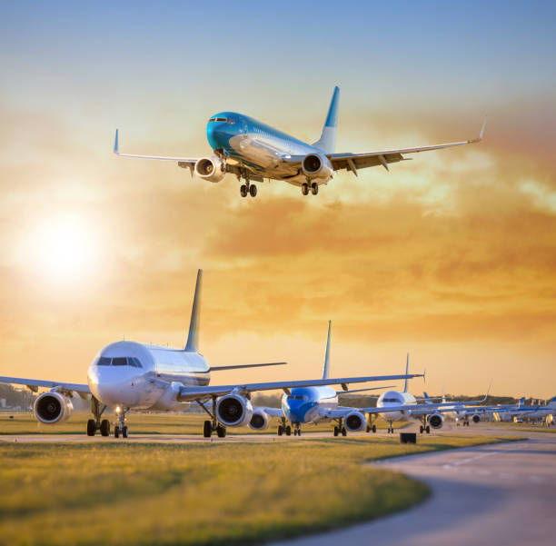 Airplane landing others standing on airfield waiting for take off Airplane landing others standing on airfield waiting for take off airfield photos stock pictures, royalty-free photos & images