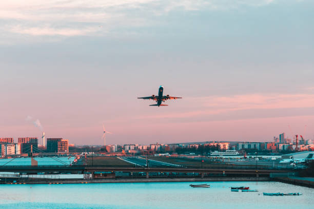 Airplane taking off from London city airport at sunset stock photo