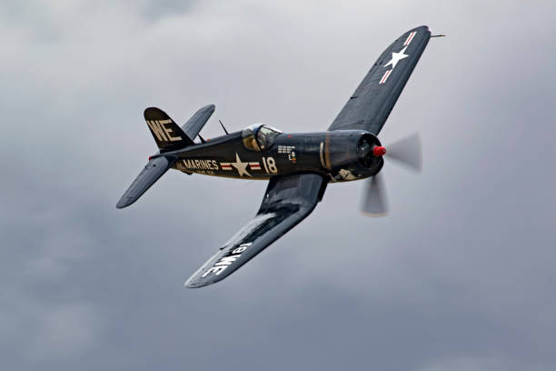 Airplane vintage WWII F4-U Corsair flying at the air show Chino, California, USA - May 6, 2017. Vintage WWII F4-U Corsair fighter plane flying at the 2017 Planes of Fame Air Show in Chino, California ww2 american fighter planes pictures stock pictures, royalty-free photos & images