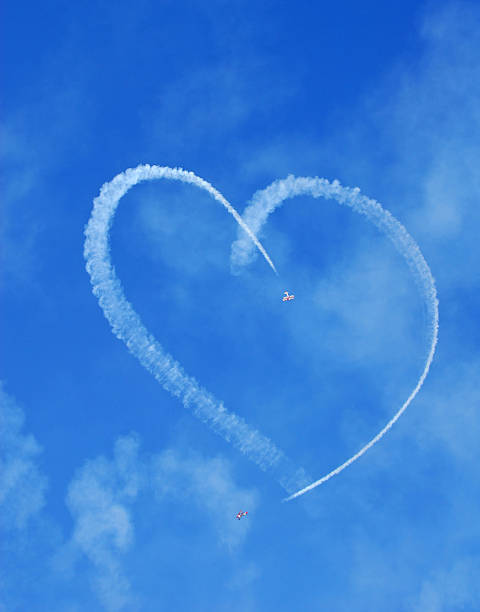 Airplanes making a heart in the sky stock photo