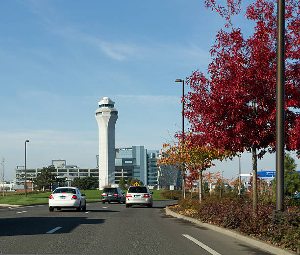 PDX Airport Control Tower in the Fall. "Portland, OR, USA - November 20, 2011: Portland International Airport\'s control tower located near the airport entrance across the street from some colorful fall trees." neicebird stock pictures, royalty-free photos & images