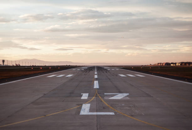 Airport runway at sunset stock photo
