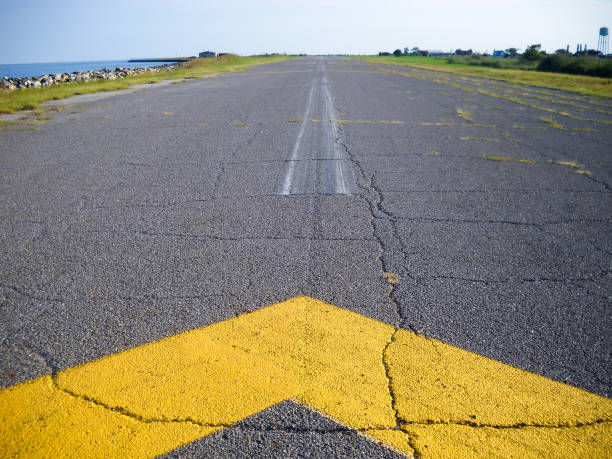 Airport runway on Tangier Island - TNG The runway to the airport on Tangier Island in the middle of the Chesapeake Bay.   Tangier island is one of the most remote places in America. tangier island stock pictures, royalty-free photos & images