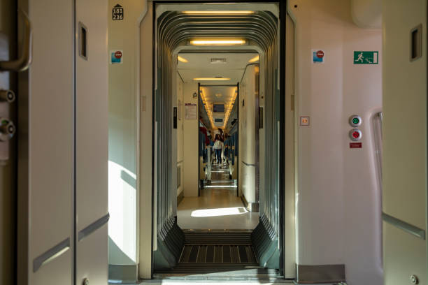 Aisle and doors in one of the wagons of a Renfe train, Madrid Madrid, Spain - June 2, 2021: The doors and aisle in one of the wagons of a Renfe Avant mid-distance train, parked at the Chamartin train station public service stock pictures, royalty-free photos & images