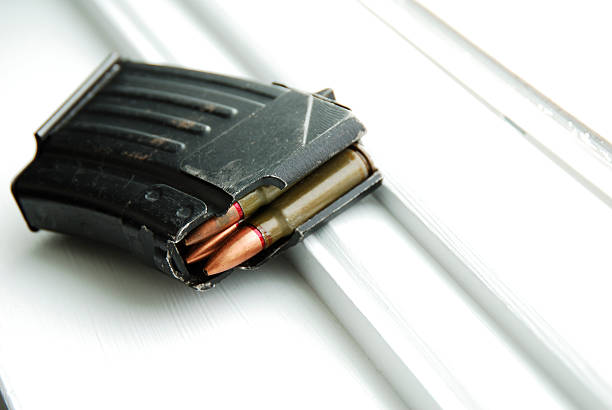 ak-47 short bullet cartridge ak-47 short bullet cartridge on white windowsill nra stock pictures, royalty-free photos & images