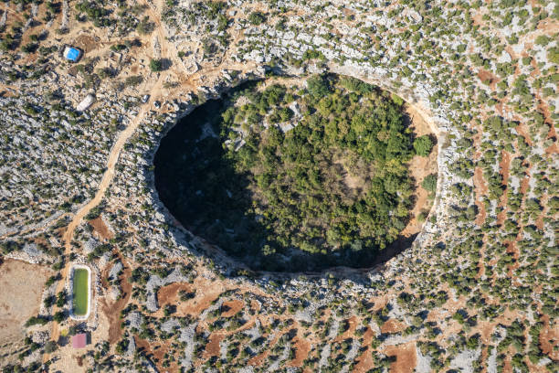 Akhayat is a sinkhole in Mersin Province, Turkey. The Akhayat Sinkhole is located in a rural area of the Silifke ilçe, to the north of Atayurt town stock photo