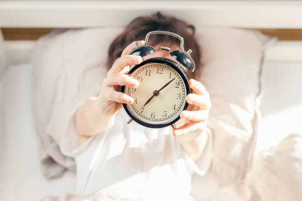 Alarm clock shows time to get up in the morning stock photo