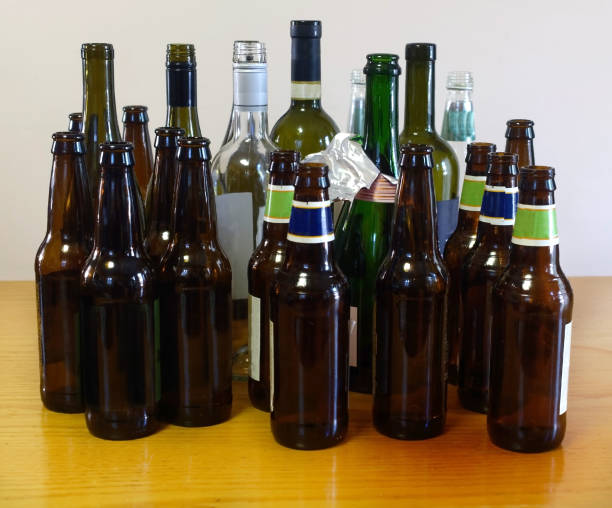 alcohol bottles on table - empty beer bottle imagens e fotografias de stock