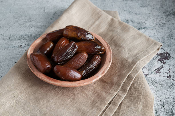 Algerian dates deglet nour on a light background in a bowl stock photo