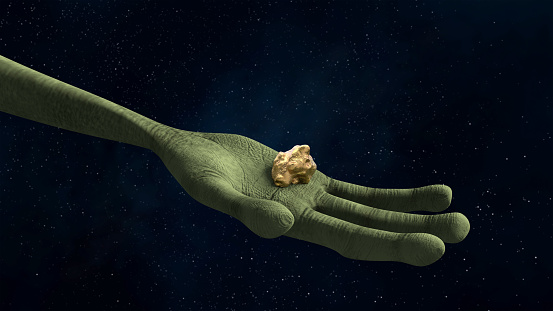 Alien hand holding a gold nugget