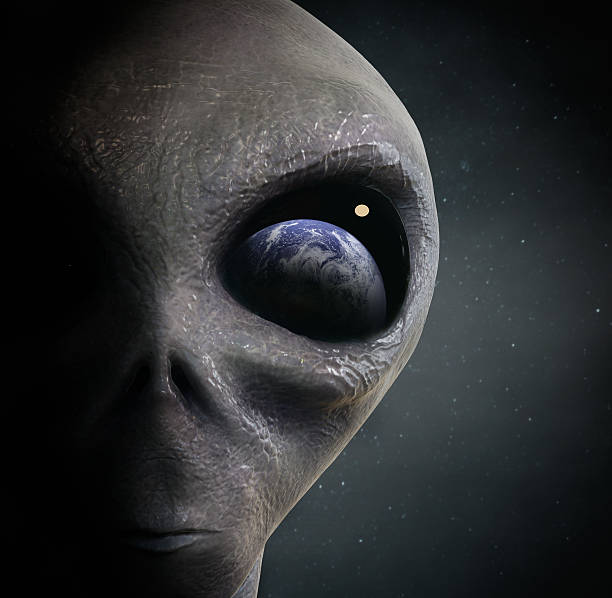 alien looking at the earth stock photo