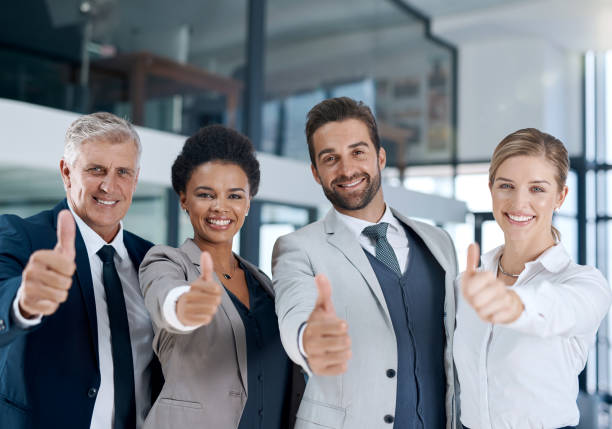 All the best from the best team Shot of a motivated business team showing thumbs up and smiling business thumbs up stock pictures, royalty-free photos & images