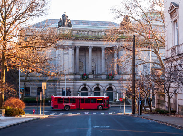 A Allegheny County Port Authority bus on Forbes Avenue in front of the Carnegie Museum of Natural History, Pittsburgh, Pennsylvania, USA stock photo