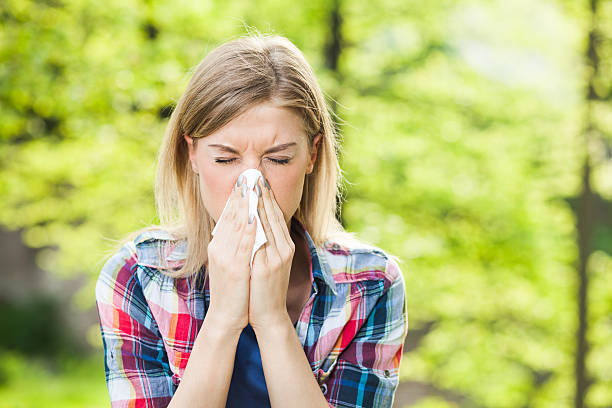 Allergy Woman with allergy symptom blowing nose sneezing stock pictures, royalty-free photos & images