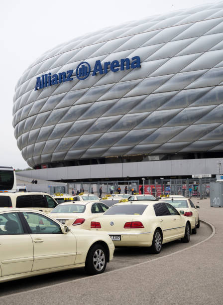 Allianz Arena, Munich Munich, Germany - 22 April 2017: Taxis are queueing up in the rain outside the Allianz Arena football stadium in Munich, Germany. With 75'000 seats, Allianz Arena is one of Germany's largest sports stadiums and home of FC Bayern Munich. Bayern München stock pictures, royalty-free photos & images