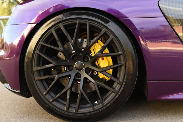 Alloy wheel with calipers and racing brakes of the sport car. Racing brake disc and low profile tyres. stock photo
