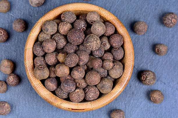 Allspice in a bamboo bowl stock photo