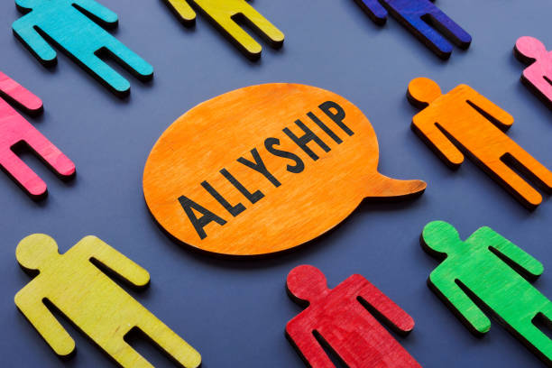 Allyship concept on the quote plate and figures. stock photo