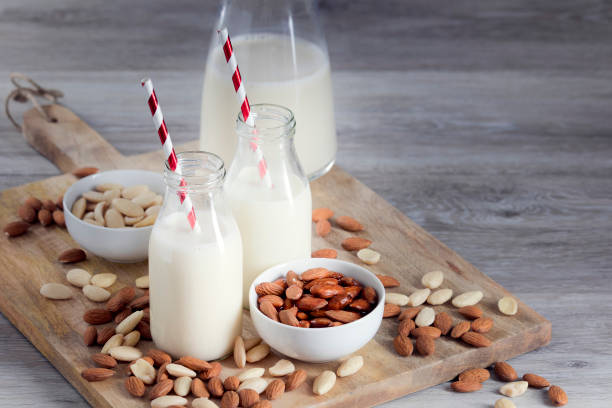 almond milk, vegan drink, peeled and unpeeled almonds, stock photo