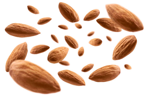 Almond nuts levitate on a white background Almond nuts levitate on a white background. almond photos stock pictures, royalty-free photos & images