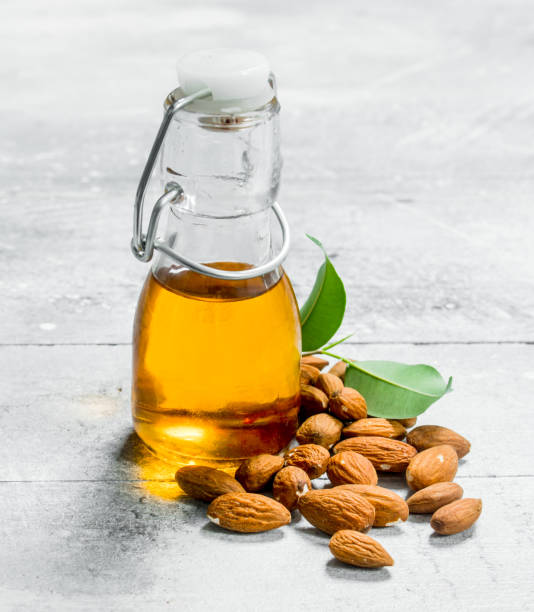 Almond oil in a glass bottle . stock photo