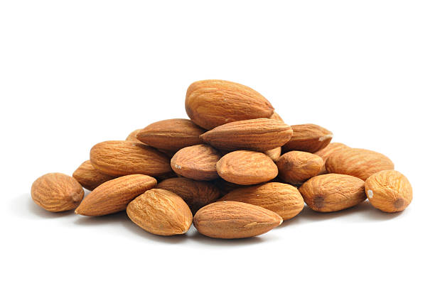 Almonds A pile of Almonds, isolated on a white background. almond stock pictures, royalty-free photos & images
